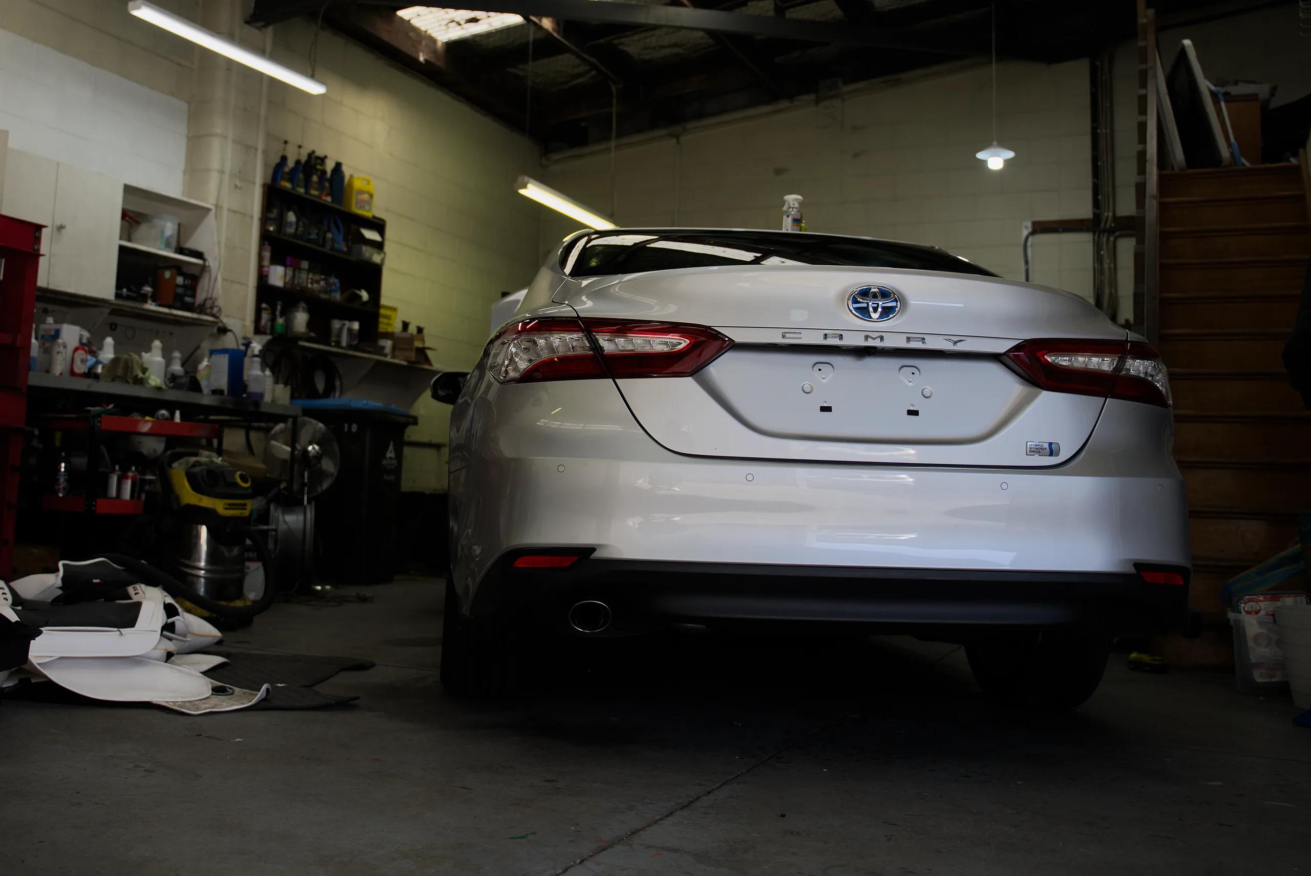 A silver Toyota Camry parked in the workshop bay